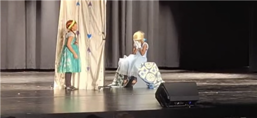 Two students performing as Elsa and Anna in Frozen Jr
